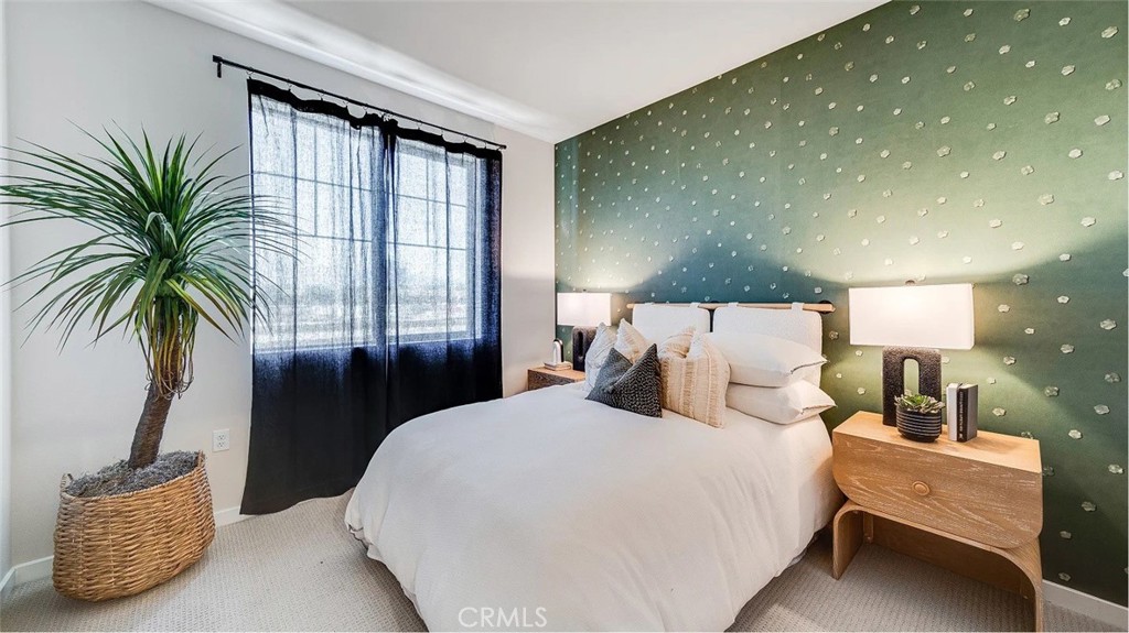 2571 Cloudview Privado Ontario, CA 91761 - Photo 9 of 19 a bedroom with a large bed and a potted plant