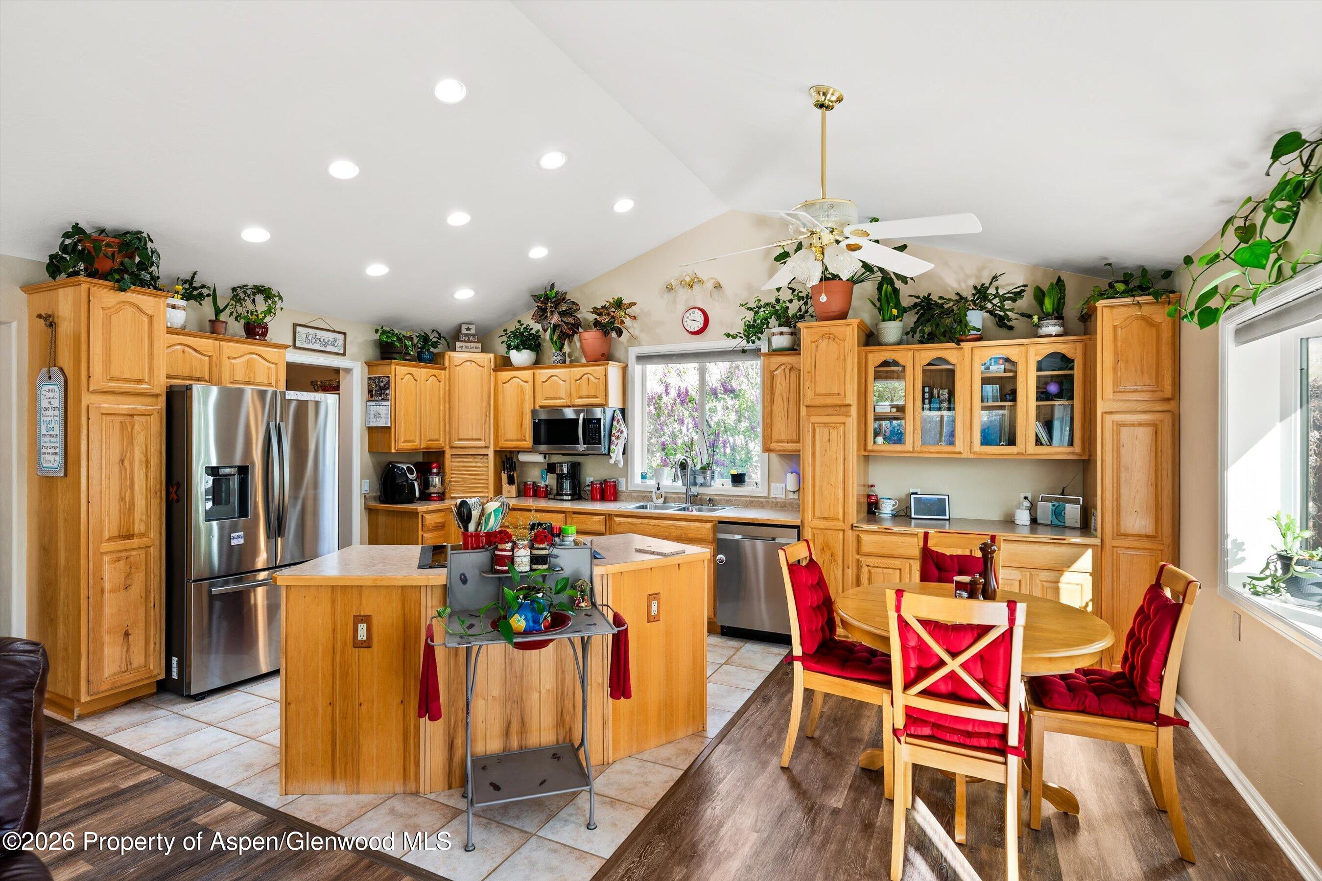 127 Cardinal Way Parachute, CO 81635 - Photo 11 of 41 a dining room with granite countertop a refrigerator and dining table