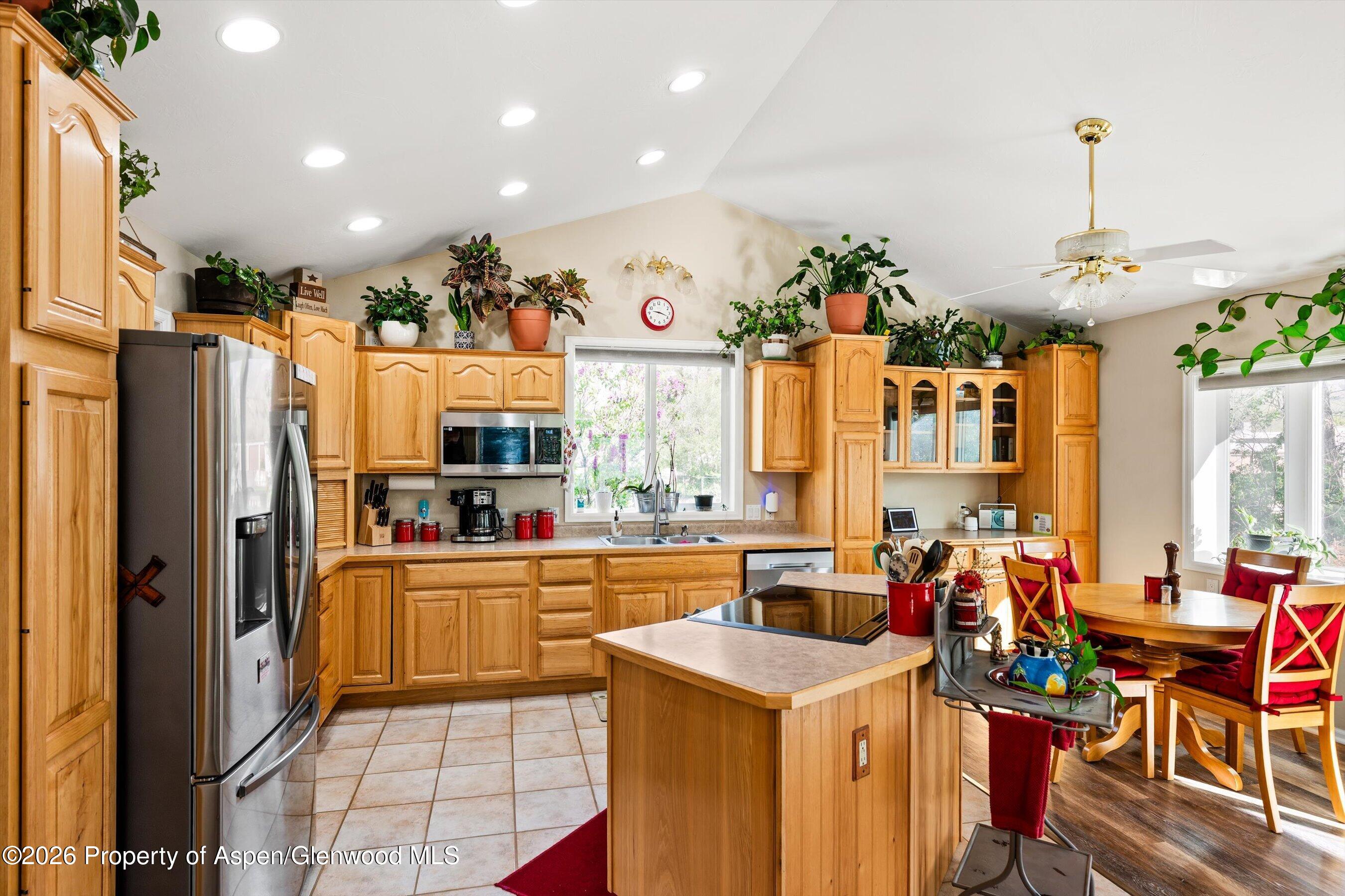 127 Cardinal Way Parachute, CO 81635 - Photo 13 of 41 a very nice looking open kitchen with stainless steel appliances granite countertop a stove and a refrigerator