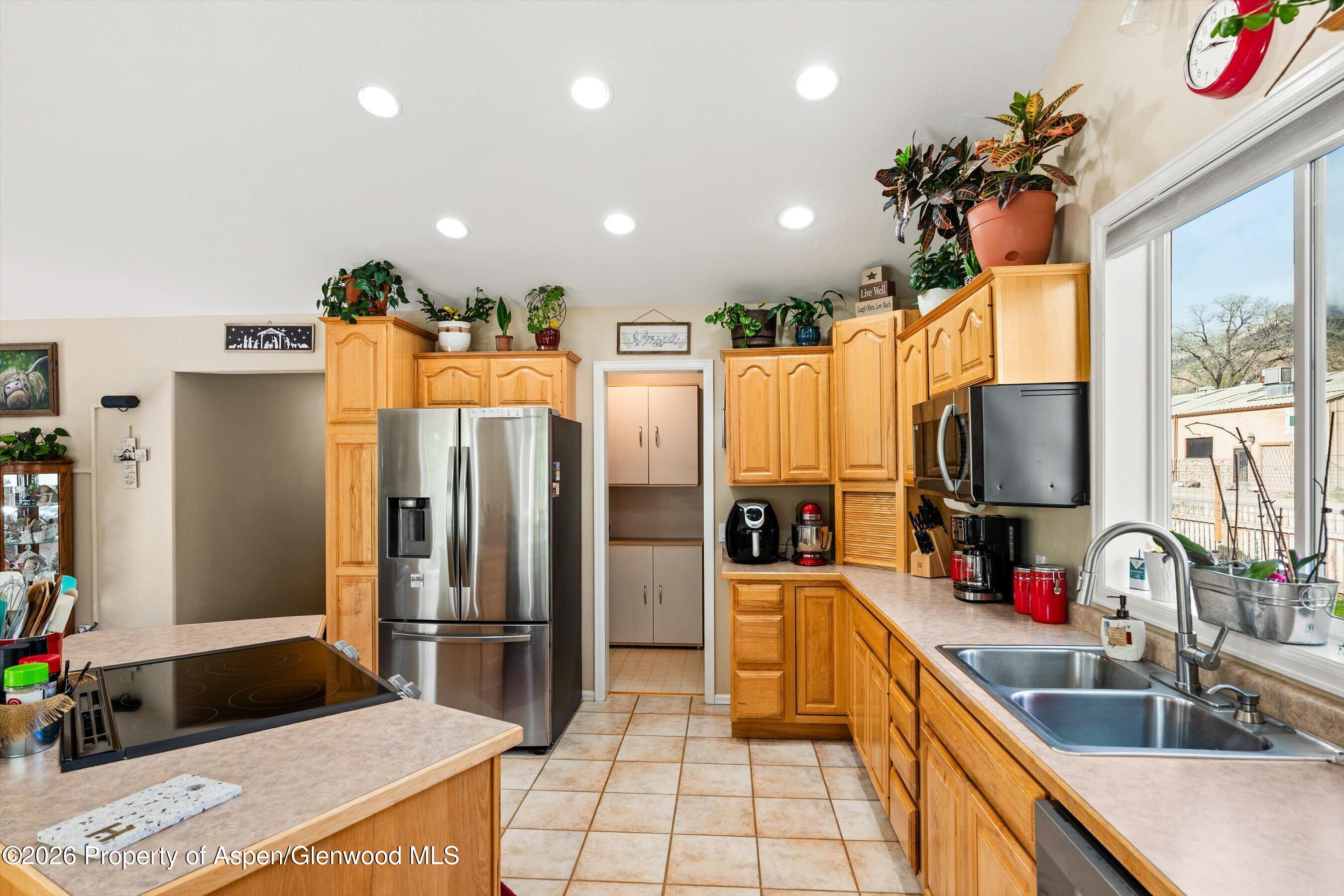 127 Cardinal Way Parachute, CO 81635 - Photo 14 of 41 a kitchen with stainless steel appliances kitchen island granite countertop a refrigerator and a sink