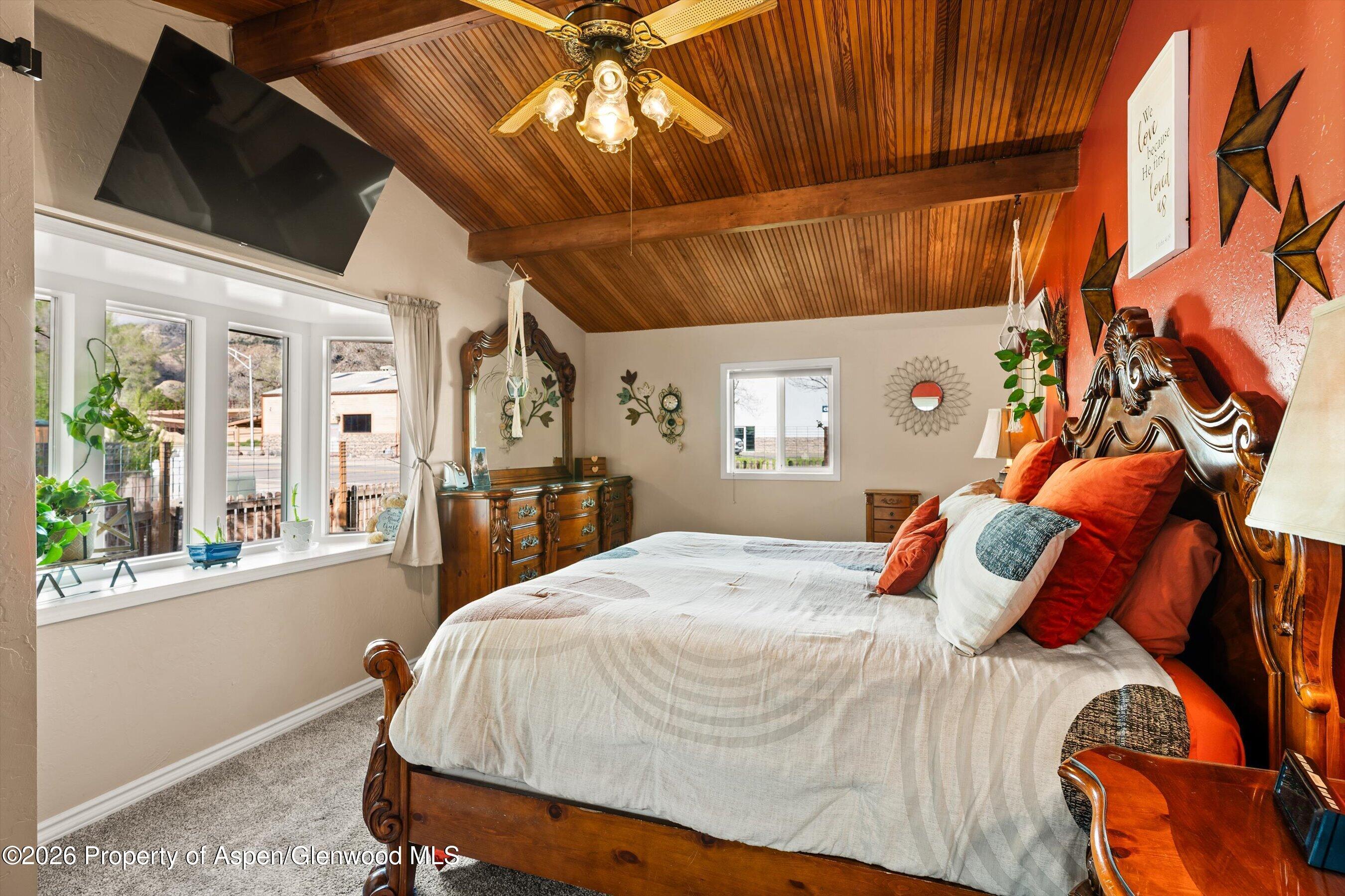 127 Cardinal Way Parachute, CO 81635 - Photo 17 of 41 a bed sitting in a bedroom next to a window