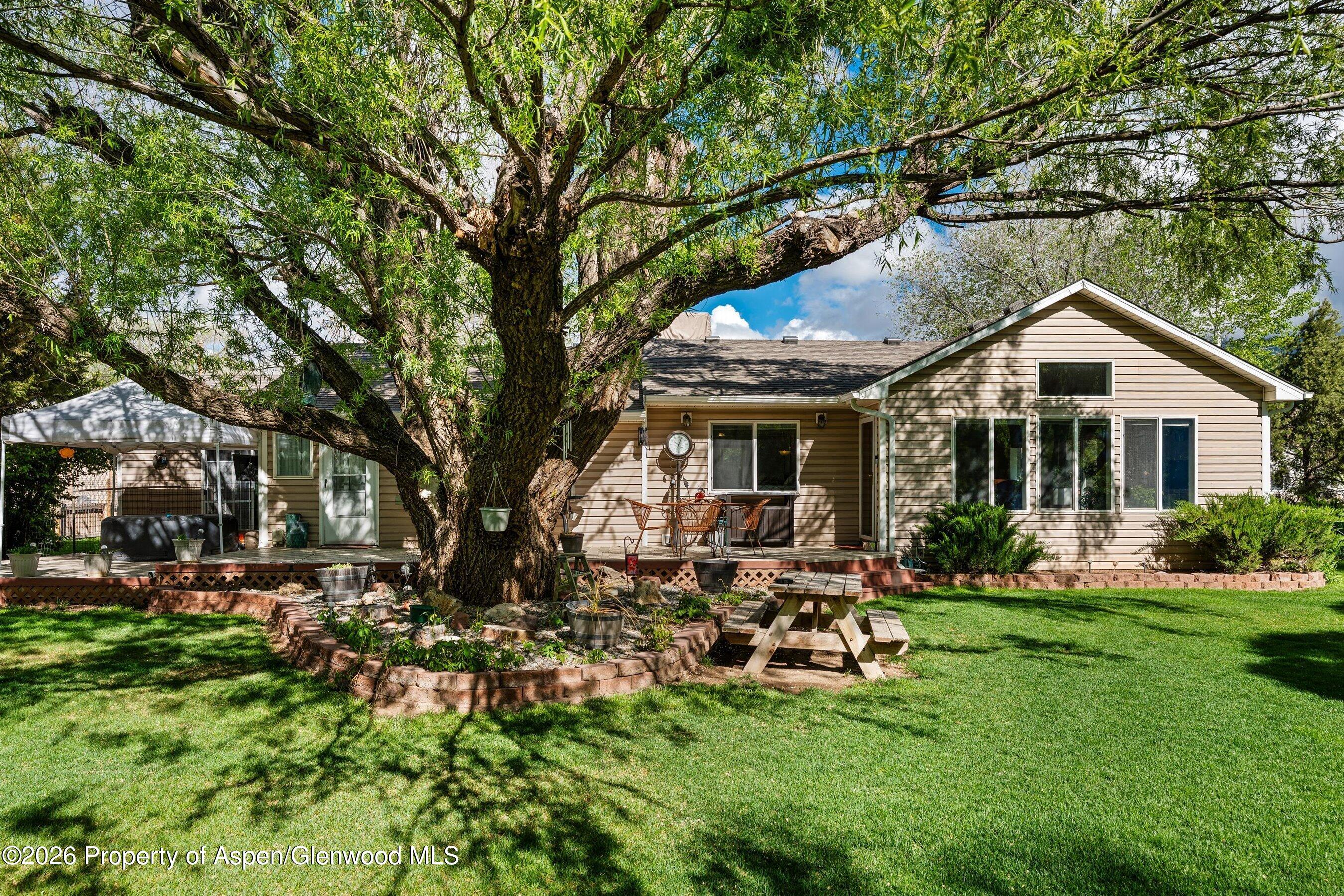 127 Cardinal Way Parachute, CO 81635 - Photo 2 of 41 a front view of house with a garden and patio