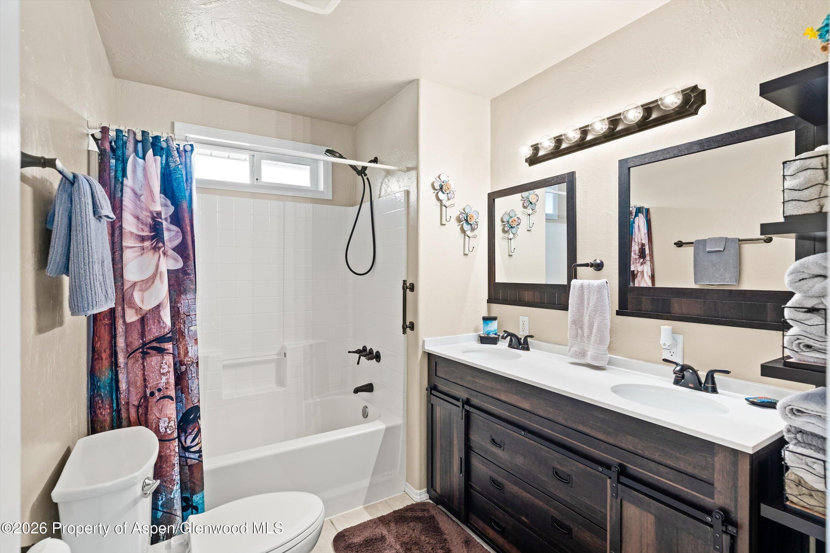 127 Cardinal Way Parachute, CO 81635 - Photo 22 of 41 a bathroom with a sink vanity granite tub toilet and shower