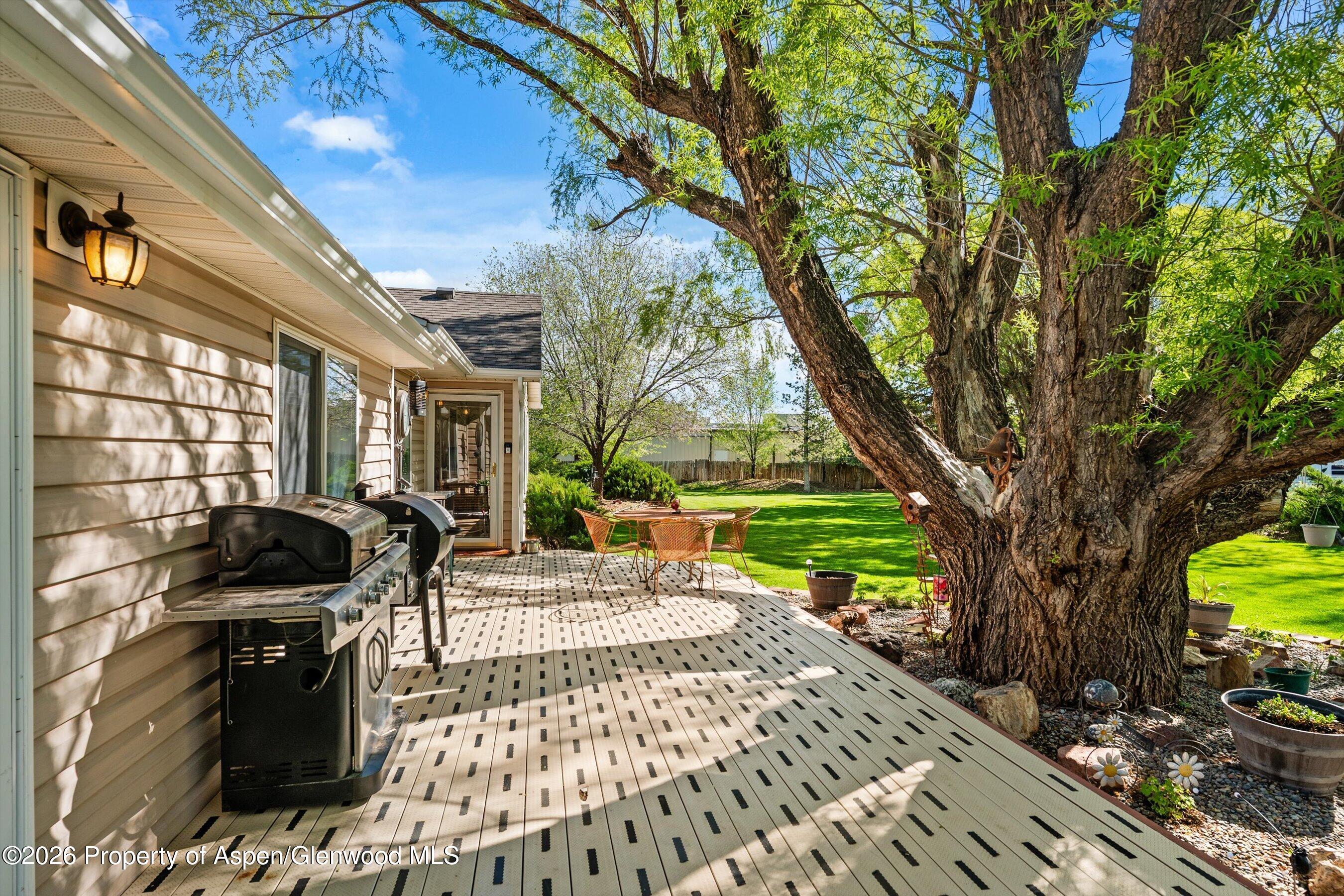 127 Cardinal Way Parachute, CO 81635 - Photo 24 of 41 a view of a patio with a table chairs and a floor to ceiling window