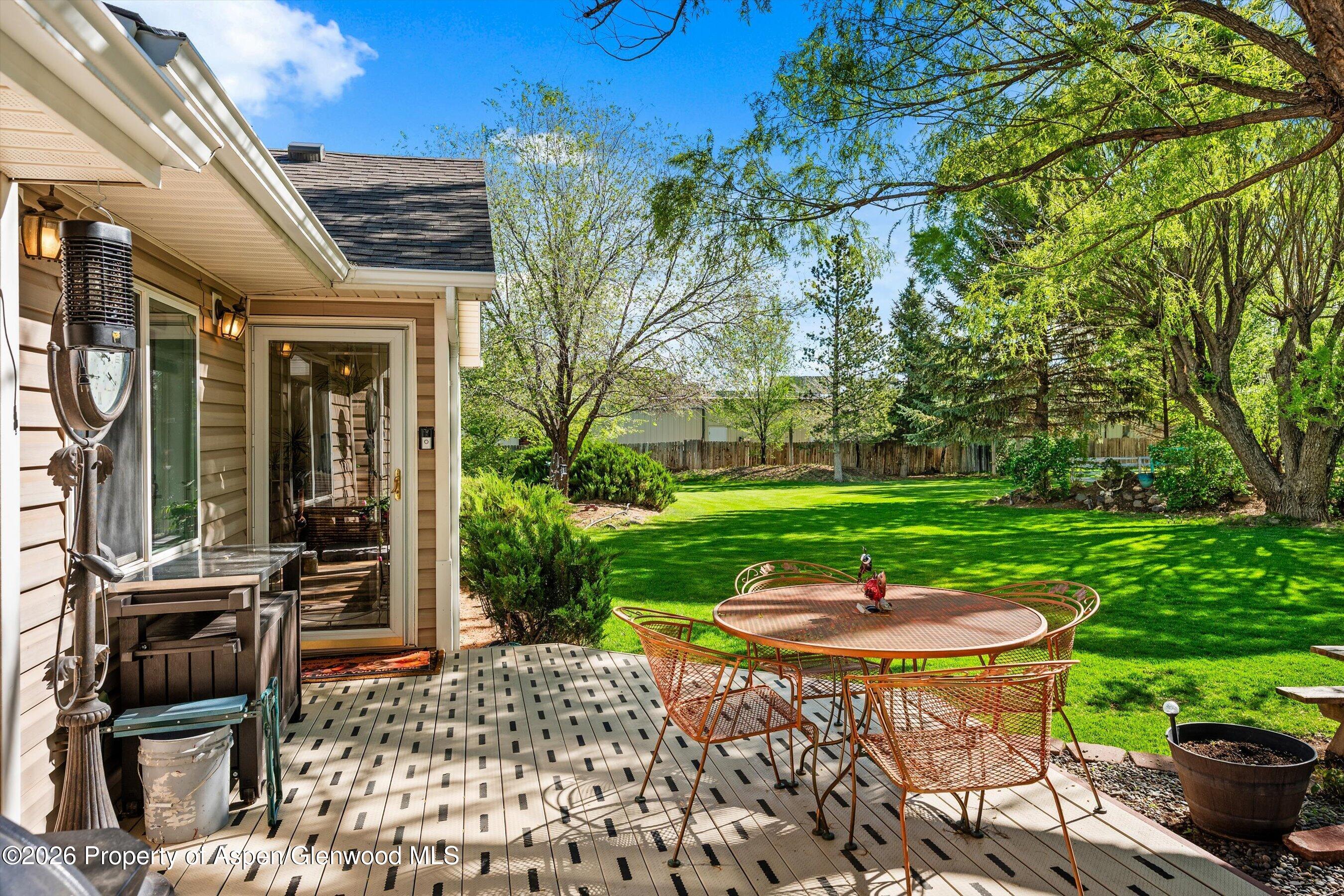 127 Cardinal Way Parachute, CO 81635 - Photo 25 of 41 a patio with a table and chairs and garden