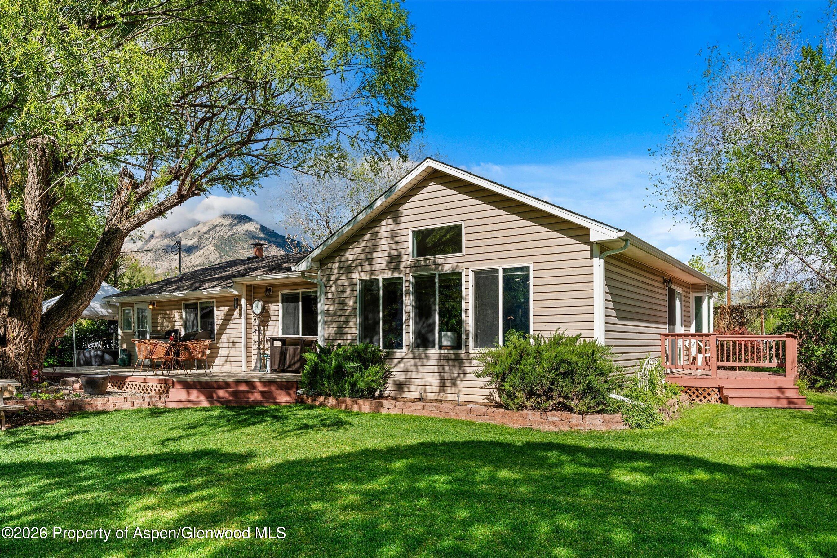 127 Cardinal Way Parachute, CO 81635 - Photo 3 of 41 a front view of house with yard and green space