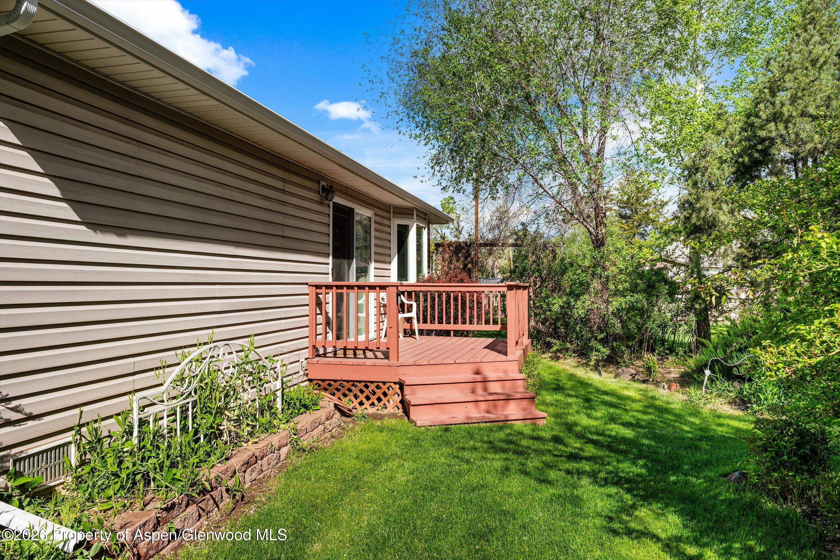 127 Cardinal Way Parachute, CO 81635 - Photo 37 of 41 a view of a house with a small yard and a deck