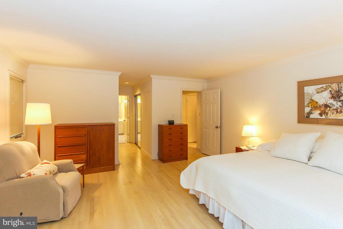 1587 Regatta Lane Reston, VA 20194 - Photo 13 of 30 a bedroom with a bed and wooden floor