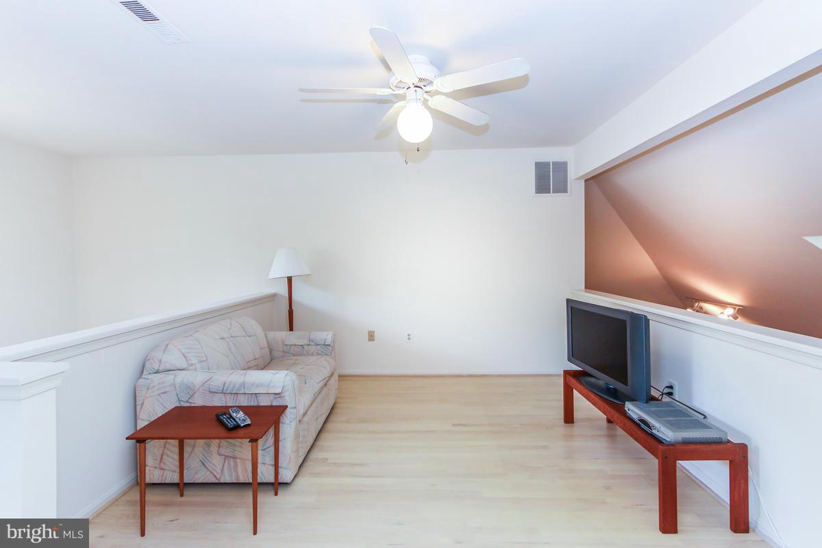 1587 Regatta Lane Reston, VA 20194 - Photo 17 of 30 a living room with furniture and a flat screen tv