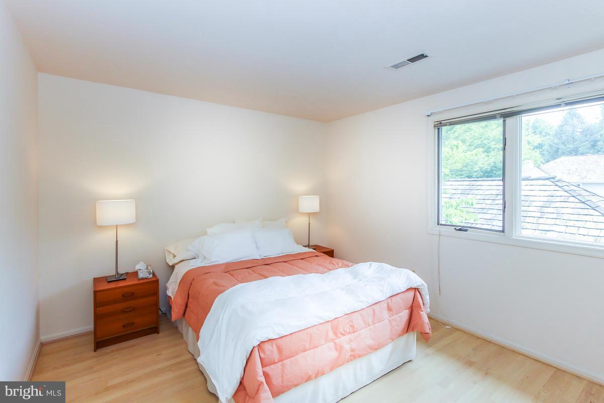1587 Regatta Lane Reston, VA 20194 - Photo 18 of 30 a bedroom with a bed and a lamp