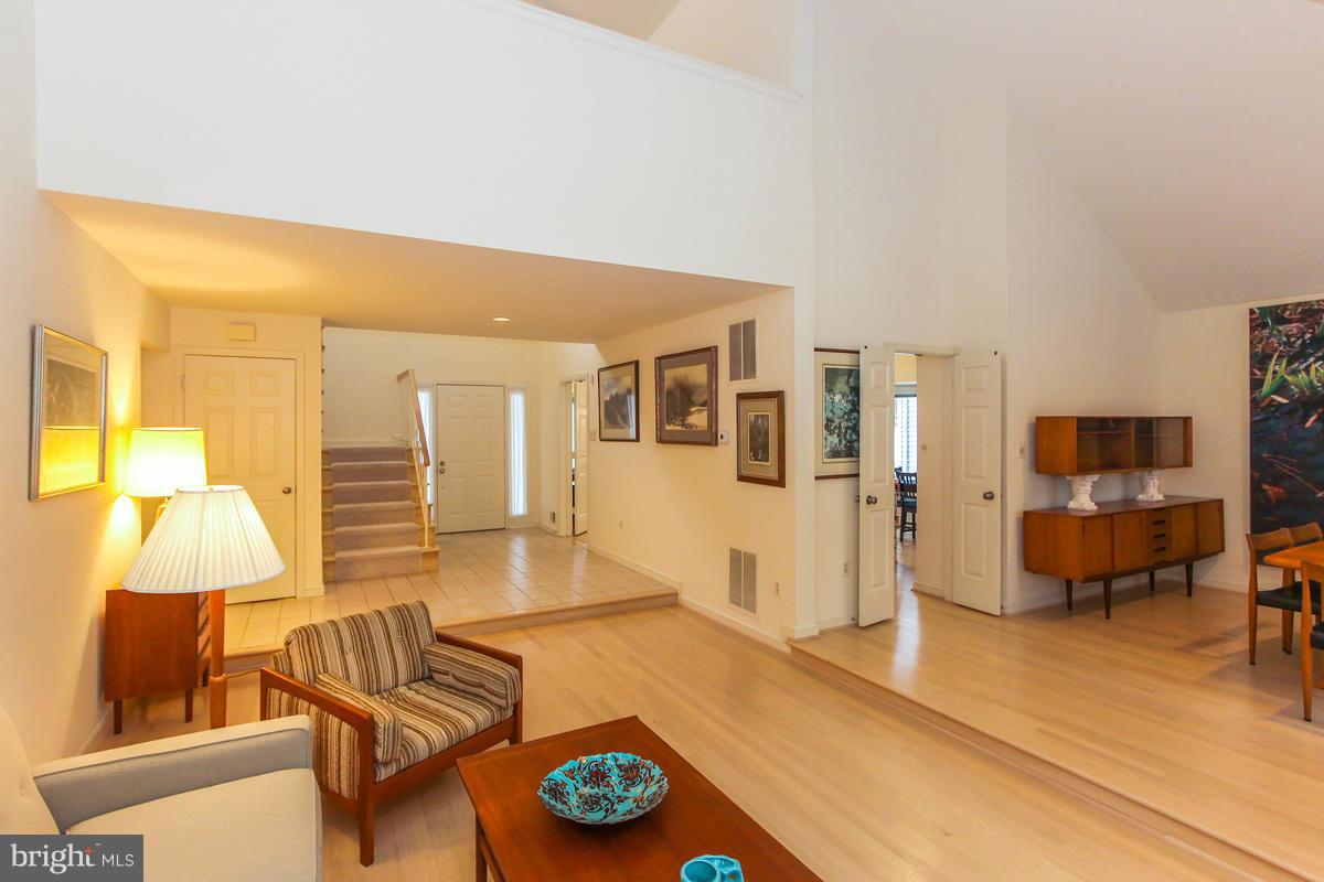 1587 Regatta Lane Reston, VA 20194 - Photo 4 of 30 a living room with furniture and a flat screen tv