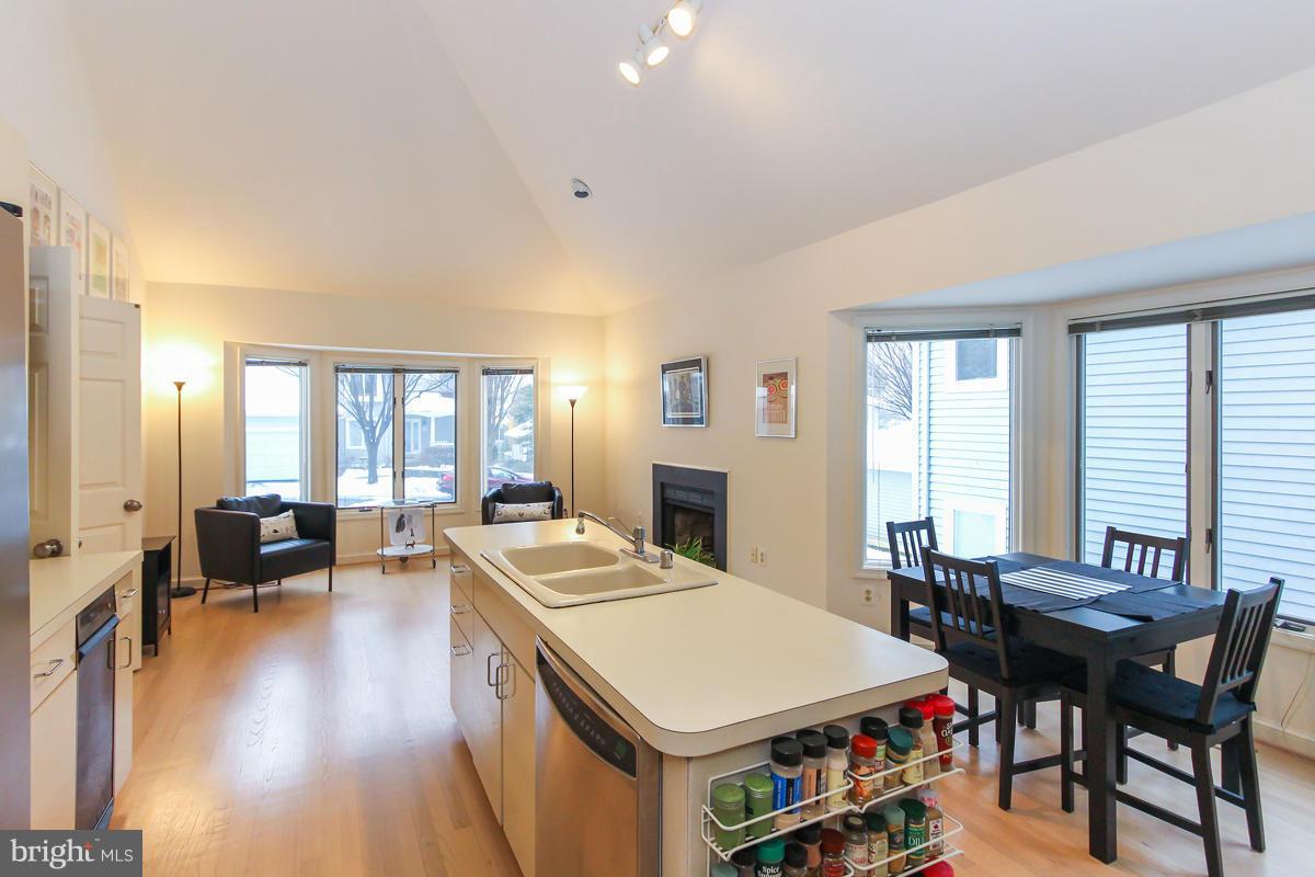1587 Regatta Lane Reston, VA 20194 - Photo 7 of 30 a room with a table chairs and a open kitchen view