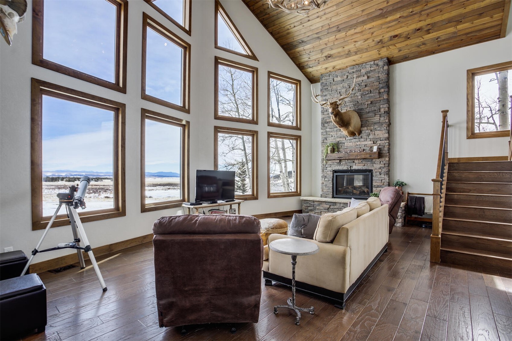 85 Warm Springs Road Fairplay, CO 80440 - Photo 4 of 32 Living room w/ huge wall of windows, gas fireplace