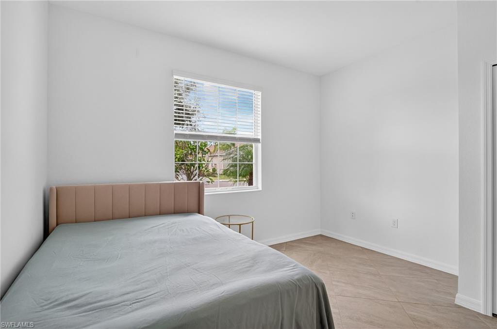 2126 Hamlin Street Naples, FL 34120 - Photo 17 of 38 a bedroom with a bed and a window