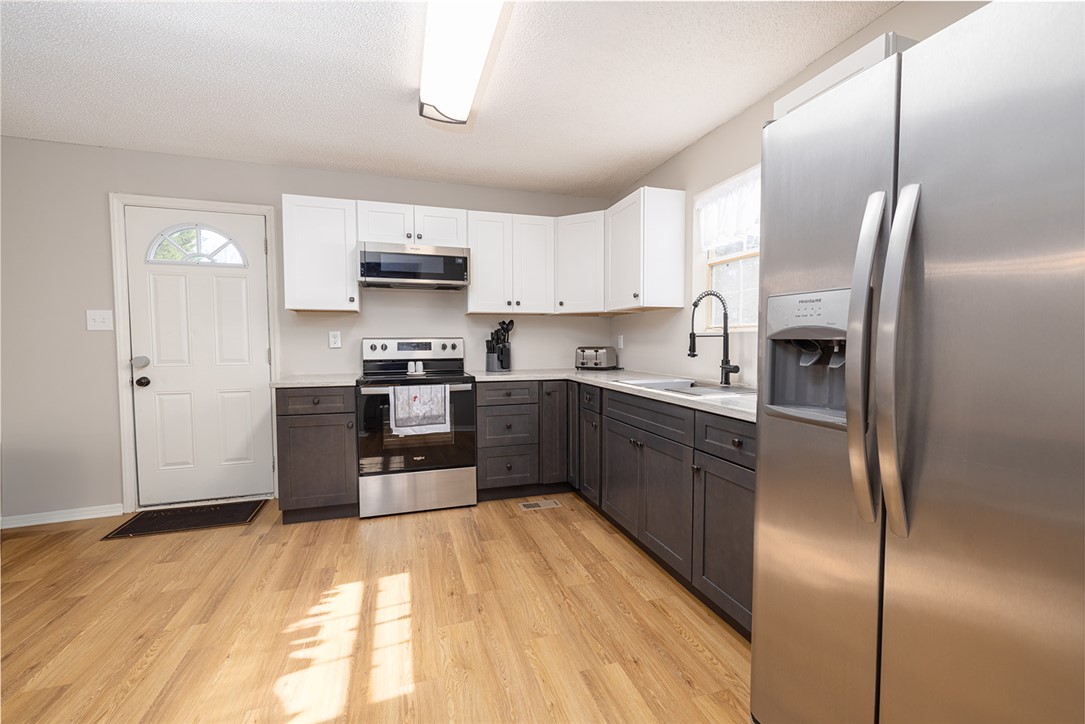 410 South Cove Road Seneca, SC 29672 - Photo 6 of 25 This functional kitchen features ample cabinetry and modern appliances, creating an inviting space for daily living.