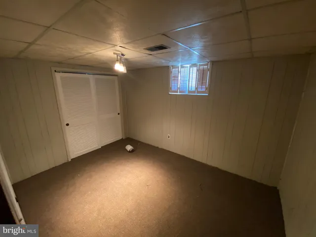 a utility room with wooden floor washer and dryer