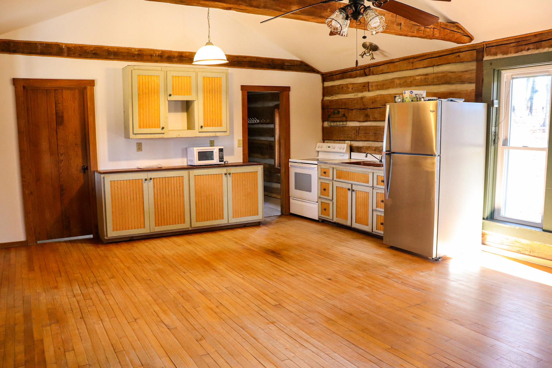 583 Alum Ridge Road Northwest Floyd, VA 24091 - Photo 4 of 22 a view of a kitchen with a stove top oven a refrigerator and a dishwasher with wooden floor