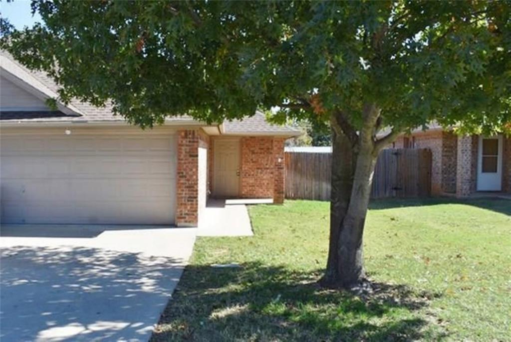 760-764 Stribling Circle Azle, TX 76020 - Photo 1 of 18 View of front of house with brick siding, driveway, a garage, and roof with shingles