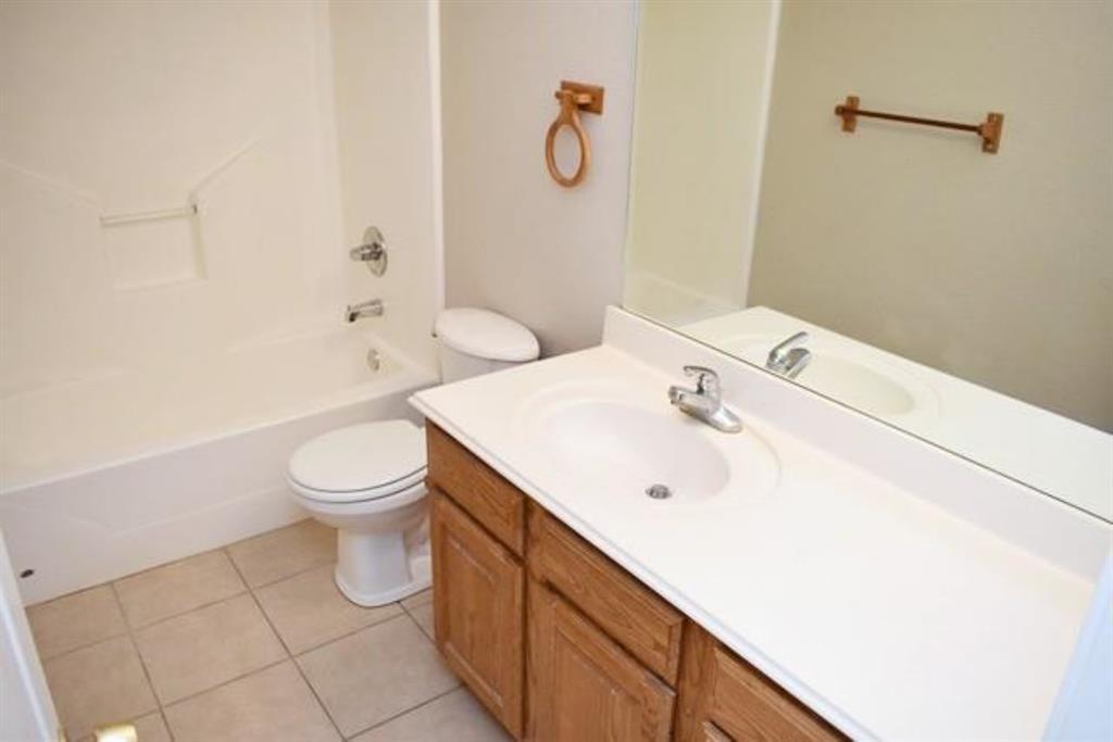 760-764 Stribling Circle Azle, TX 76020 - Photo 4 of 18 Full bathroom featuring vanity, shower / bath combination, and light tile patterned flooring