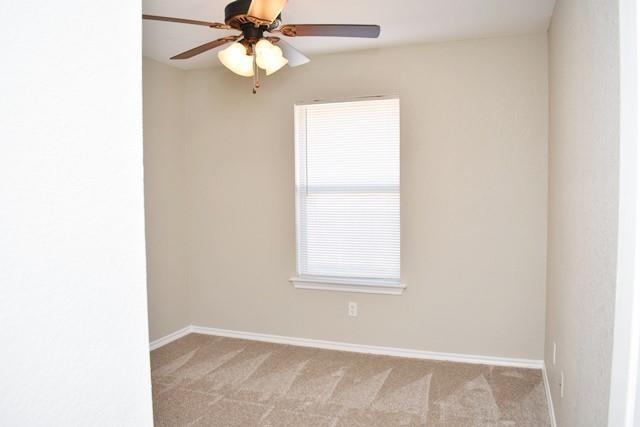 760-764 Stribling Circle Azle, TX 76020 - Photo 9 of 18 Unfurnished room with light carpet and ceiling fan
