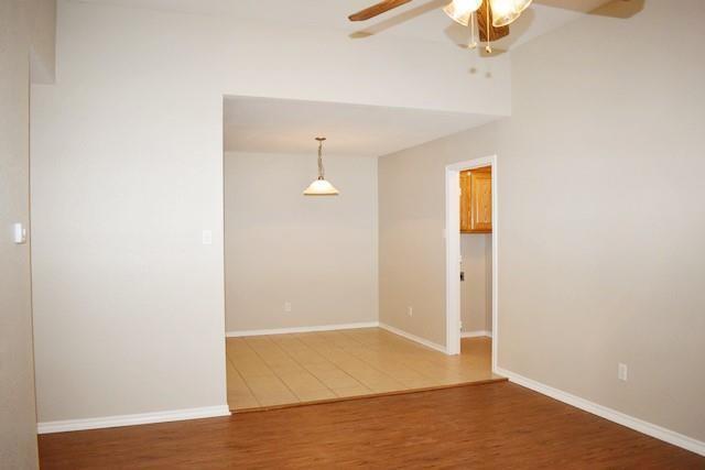 760-764 Stribling Circle Azle, TX 76020 - Photo 10 of 18 Empty room with light wood finished floors and ceiling fan