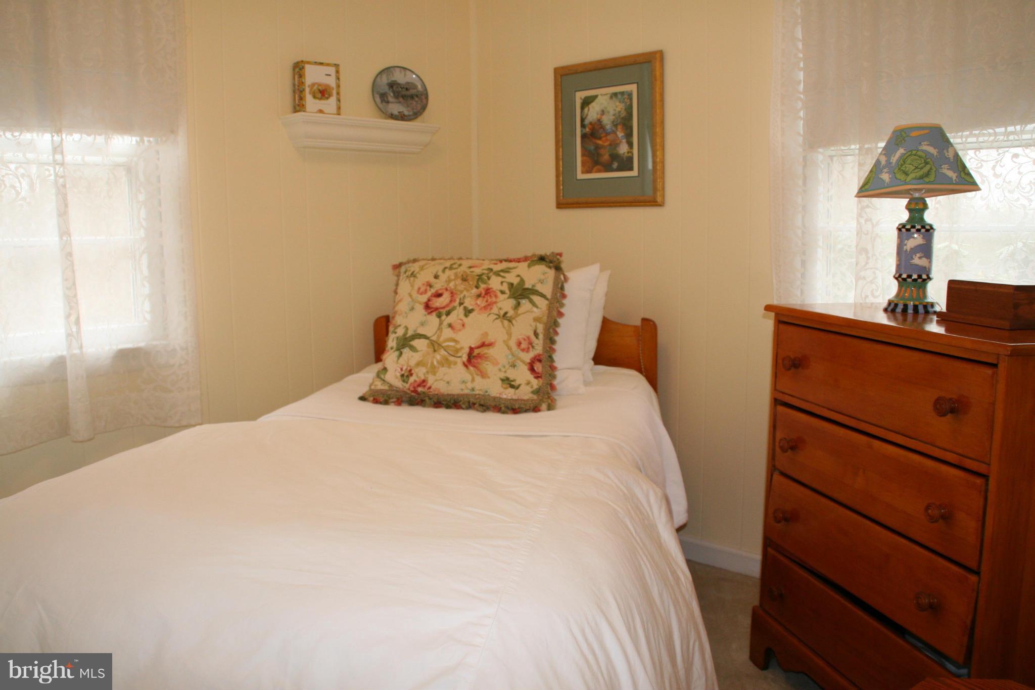 6606 Howellsville Road Front Royal, VA 22630 - Photo 18 of 30 a bedroom with a bed and a lamp on the dresser