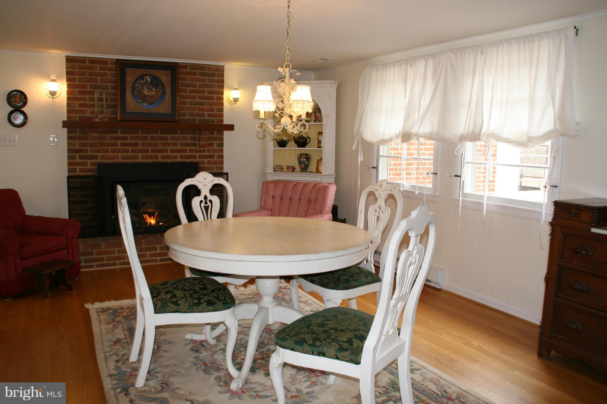 6606 Howellsville Road Front Royal, VA 22630 - Photo 3 of 30 a dining room with furniture a chandelier and wooden floor