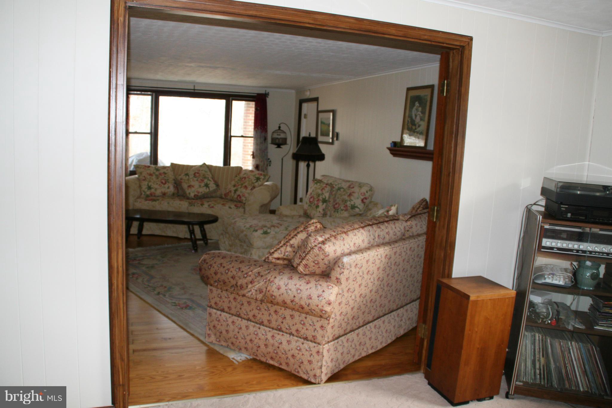 6606 Howellsville Road Front Royal, VA 22630 - Photo 23 of 30 a living room with furniture and a potted plant