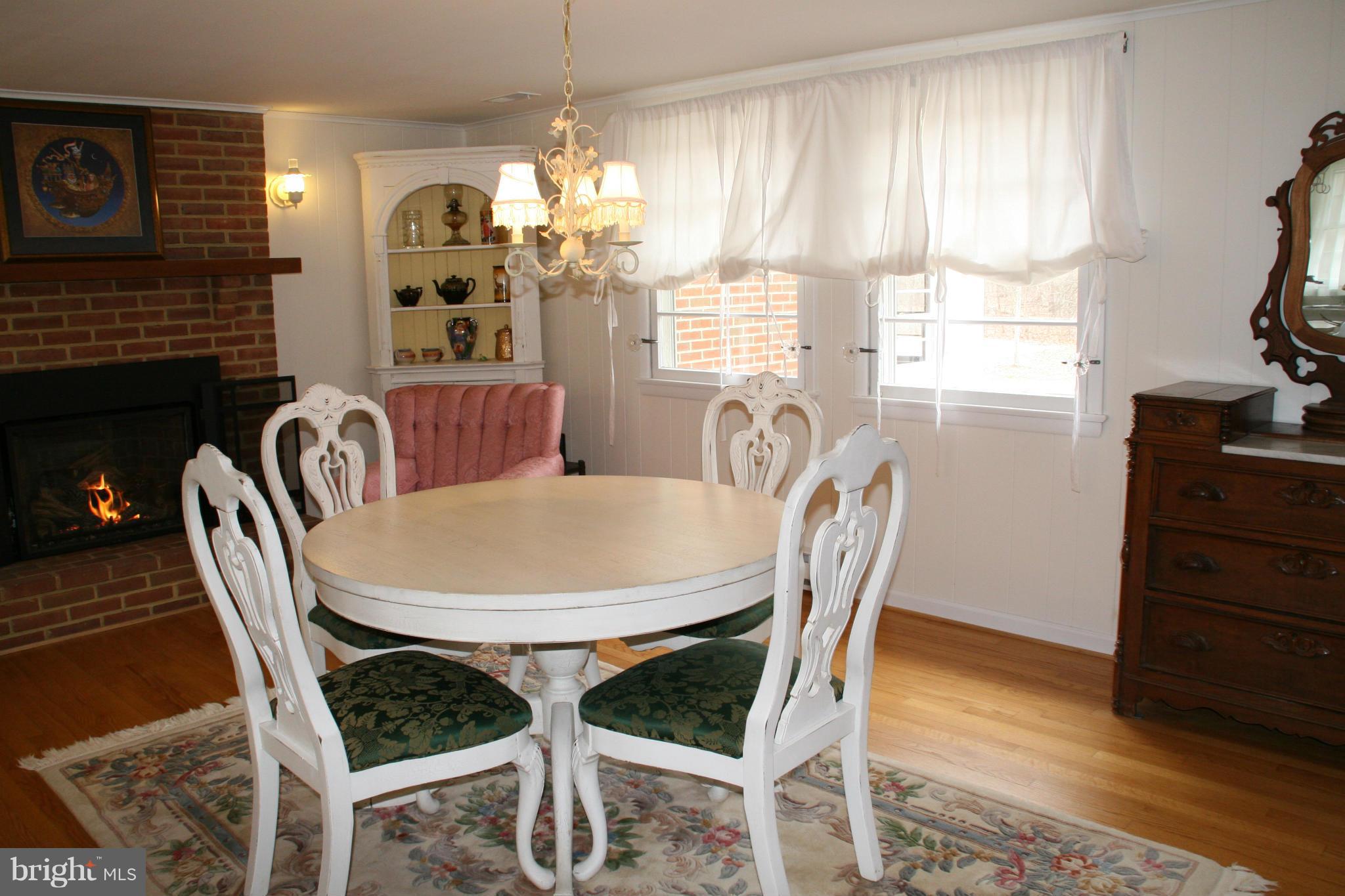 6606 Howellsville Road Front Royal, VA 22630 - Photo 5 of 30 a dining room with furniture a window and wooden floor