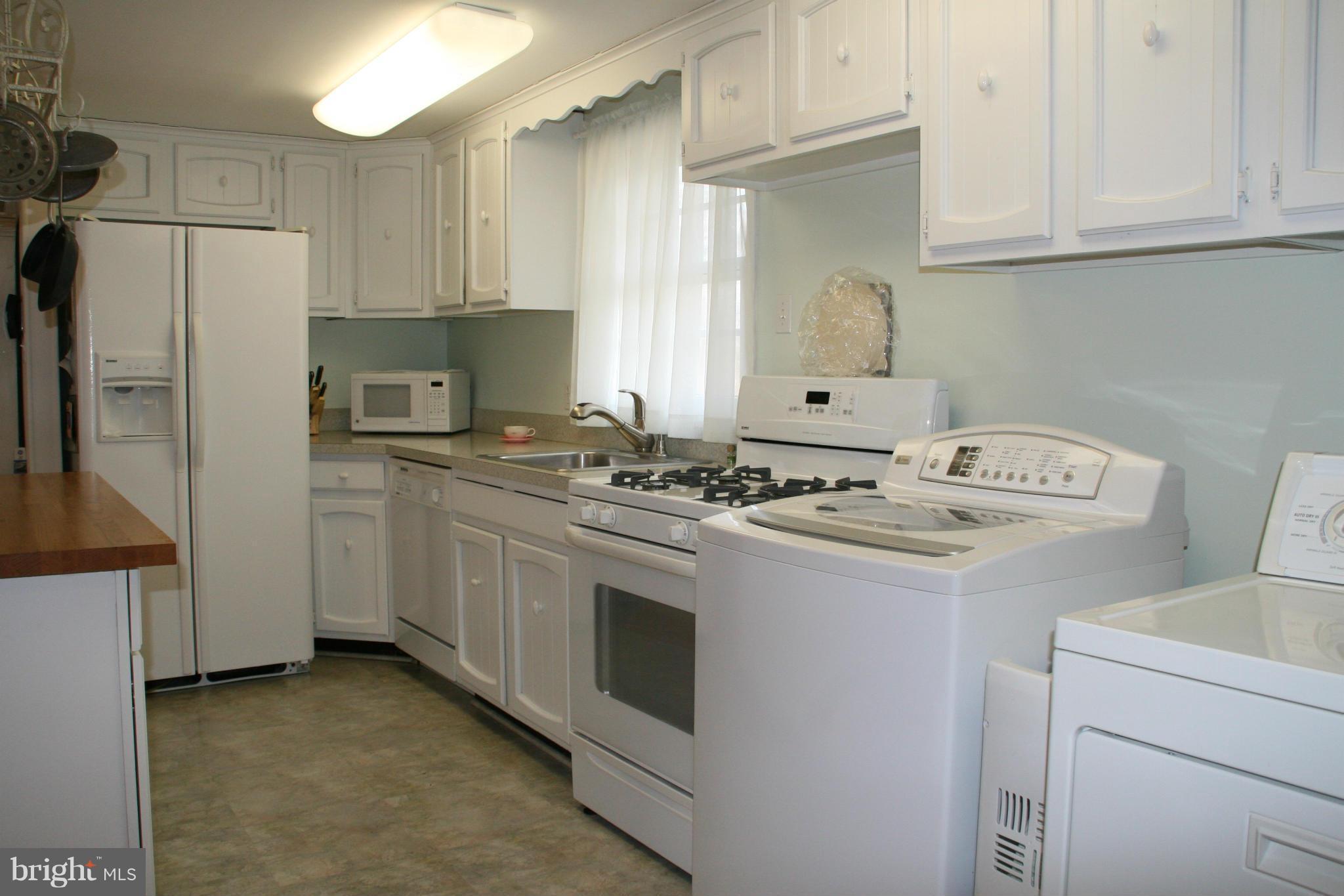 6606 Howellsville Road Front Royal, VA 22630 - Photo 9 of 30 a kitchen with appliances a sink and a refrigerator