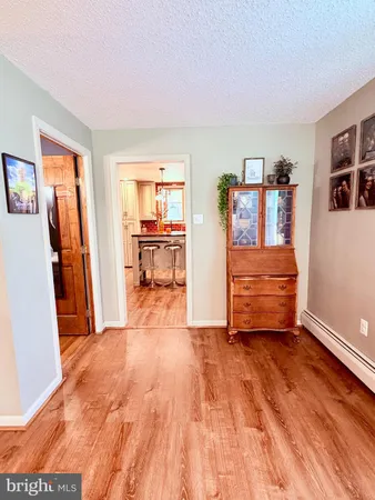a kitchen with granite countertop a refrigerator stove top oven and sink