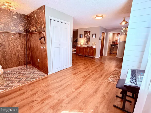 a living room with furniture rug and wooden floor