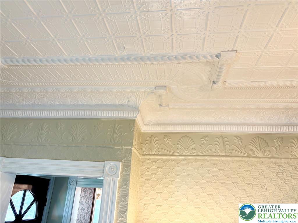 7241 Decatur Street New Tripoli, PA 18066 - Photo 8 of 36 Ornate ceiling moldings and intricate wall textures enrich the living space.