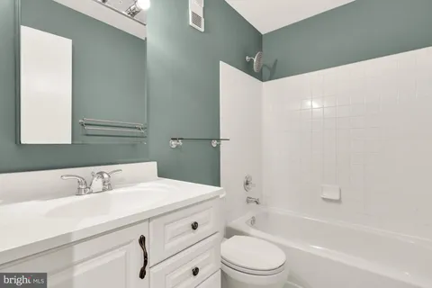 a bathroom with a sink a toilet and bathtub