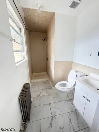 a bathroom with a toilet a sink and a window