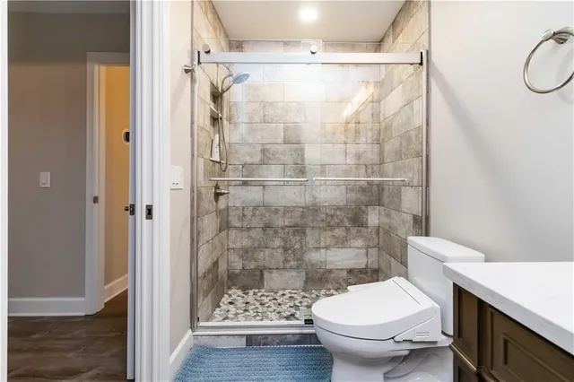 a bathroom with a toilet and a shower