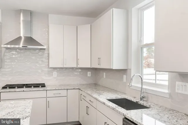 a kitchen with a sink cabinets and window