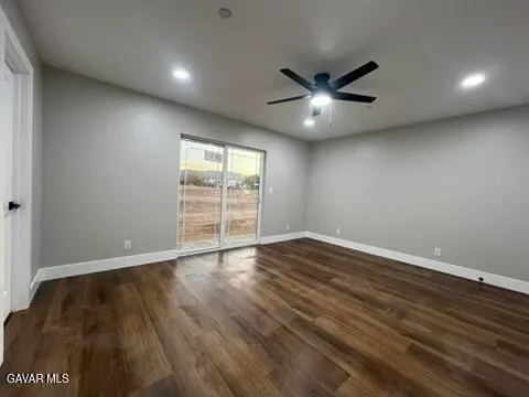 a kitchen that has a lot of white cabinets and stainless steel appliances