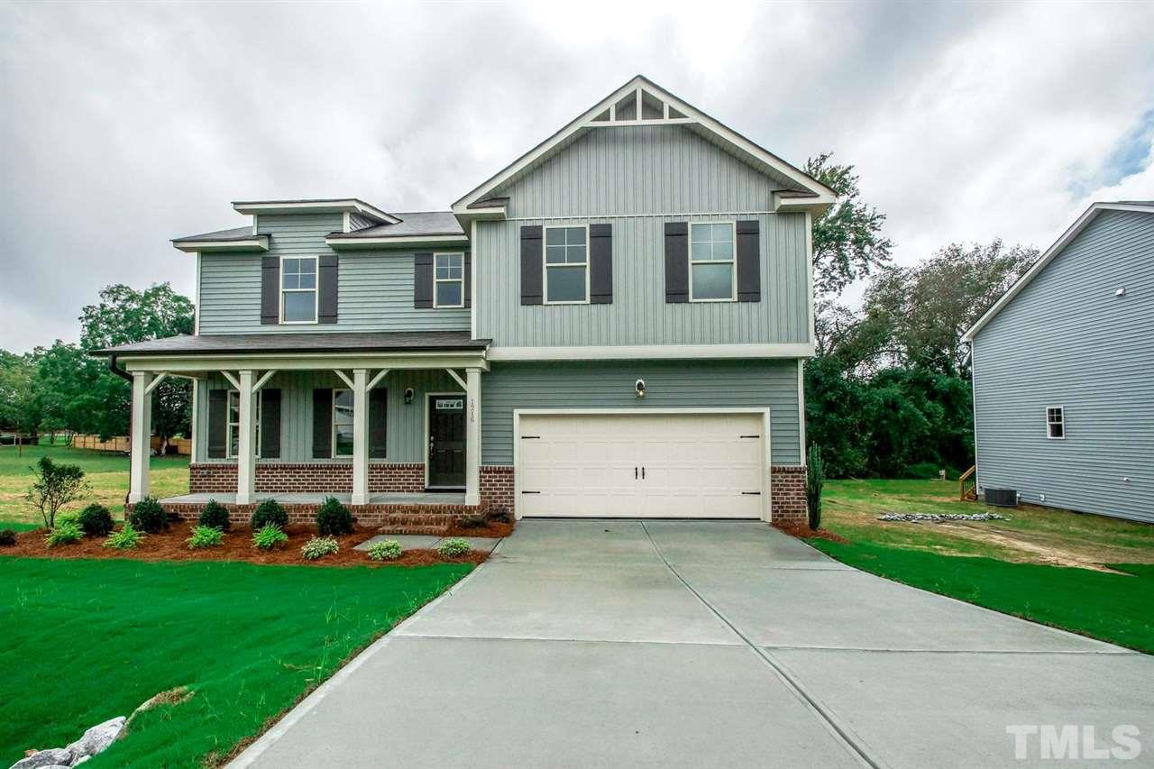 1216 Silver Farm Road Raleigh, NC 27603 - Photo 1 of 25 a front view of a house with a yard and trees