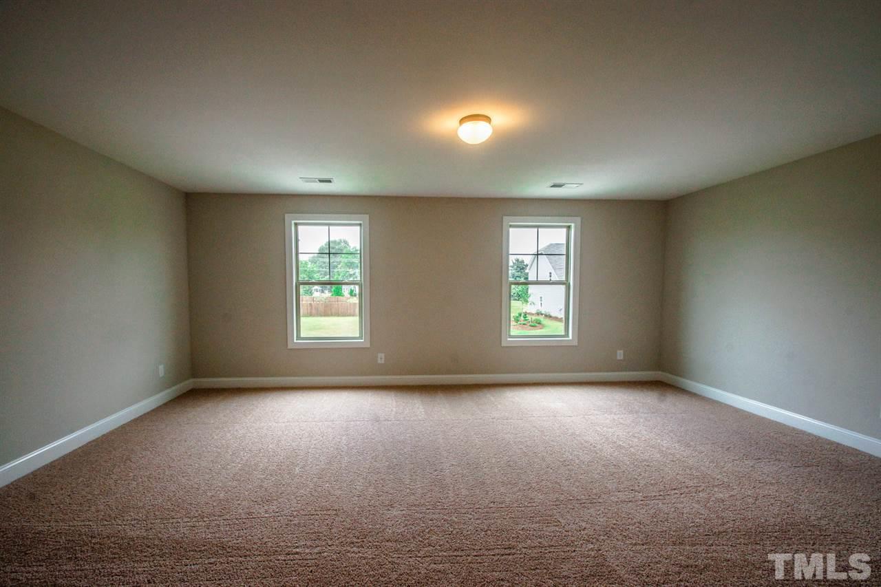 1216 Silver Farm Road Raleigh, NC 27603 - Photo 11 of 25 an empty room with windows
