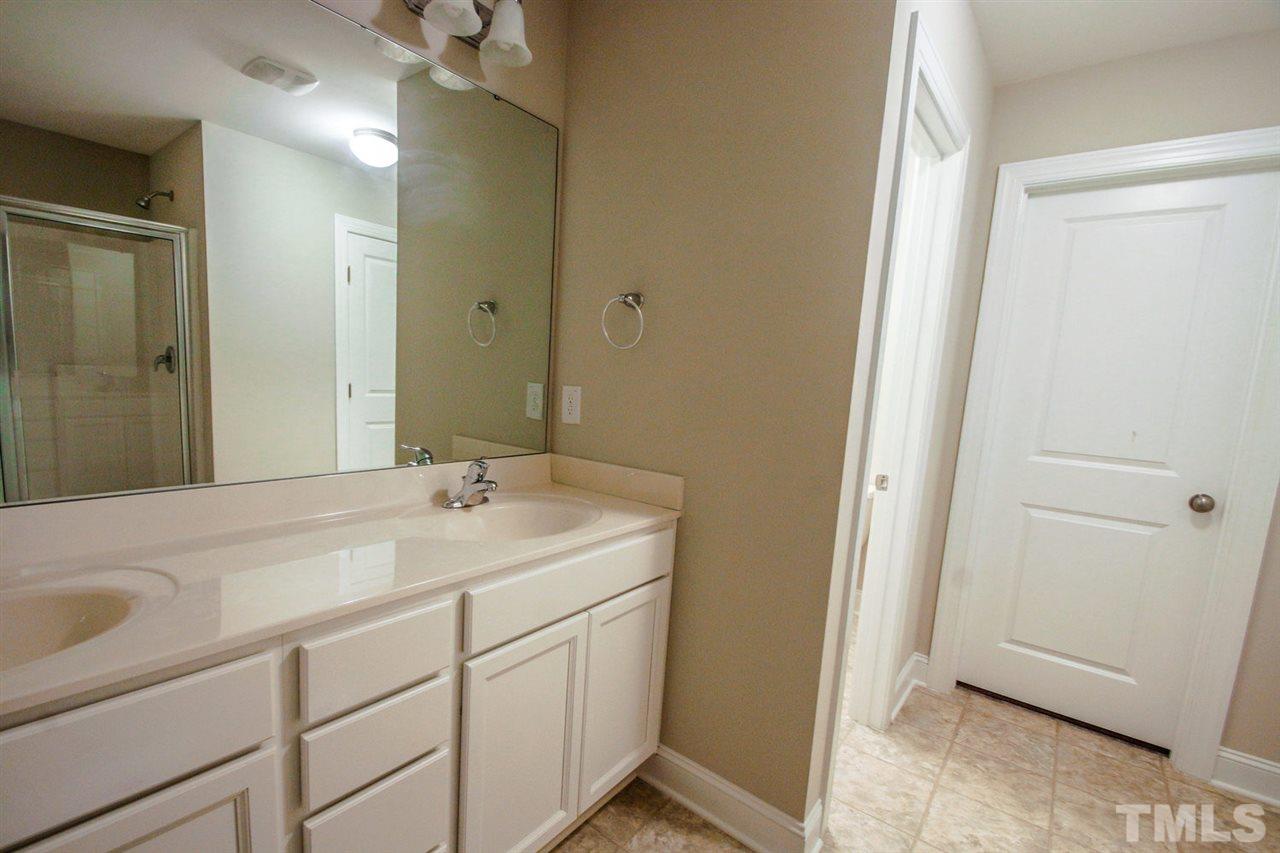 1216 Silver Farm Road Raleigh, NC 27603 - Photo 12 of 25 a bathroom with a sink and a mirror