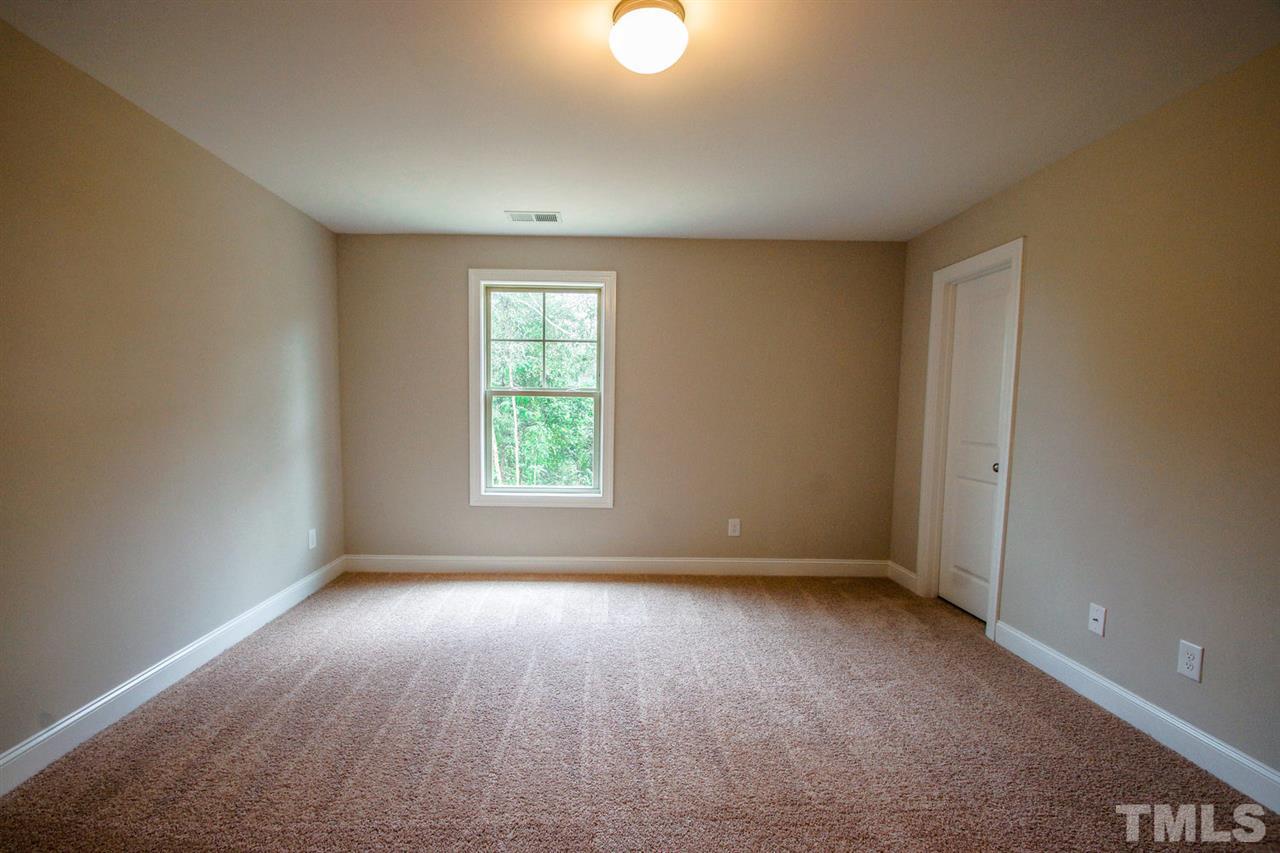 1216 Silver Farm Road Raleigh, NC 27603 - Photo 13 of 25 an empty room with windows