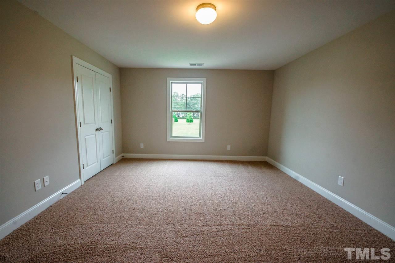 1216 Silver Farm Road Raleigh, NC 27603 - Photo 18 of 25 an empty room with windows and closet
