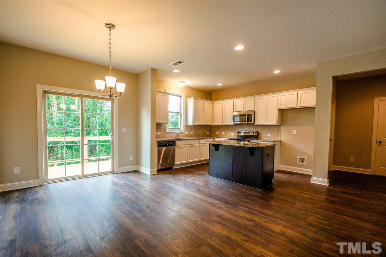 1216 Silver Farm Road Raleigh, NC 27603 - Photo 8 of 25 a large kitchen with stainless steel appliances granite countertop a stove top oven and a wooden floors