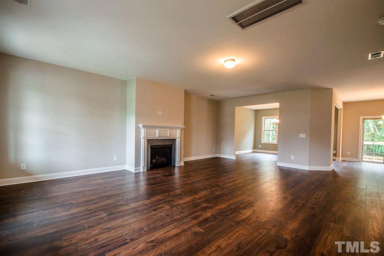 1216 Silver Farm Road Raleigh, NC 27603 - Photo 9 of 25 a view of an empty room with wooden floor and a window