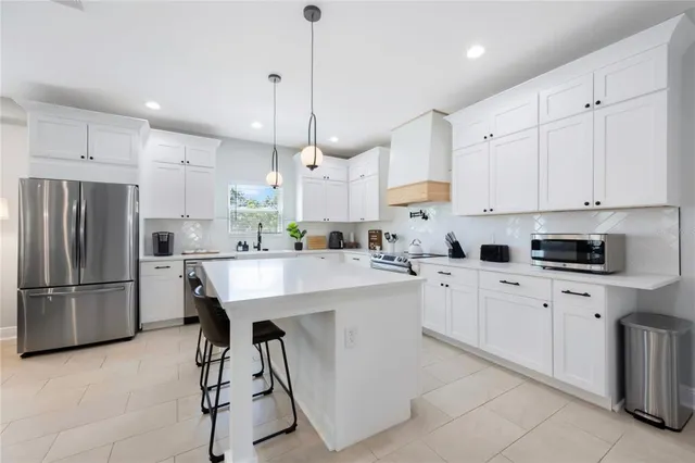 a en suite bathroom with a granite countertop sink and a mirror