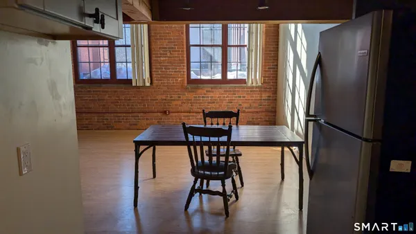 a view of a dining room with furniture window and wooden floor