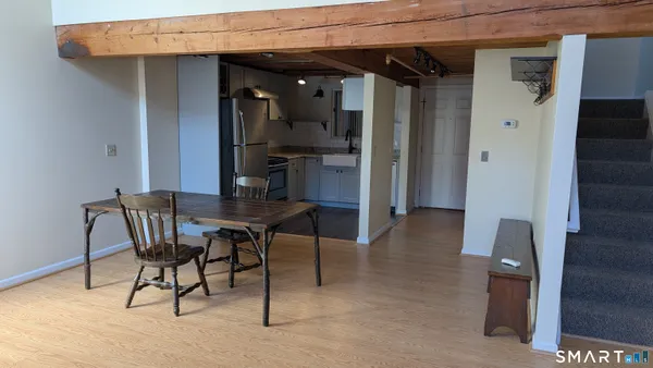 a dining room with furniture and wooden floor
