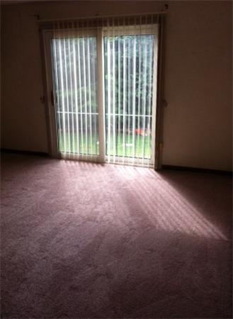 176 Swanson Road, Unit 312 Boxborough, MA 01719 - Photo 4 of 17 a view of an empty room with a balcony