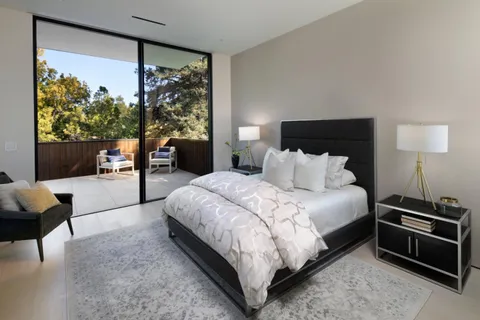 a bedroom with a large bed and a window